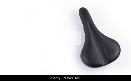 Bicycle saddle in black on a white background, close-up top view. copyspace for text. Stock Photo
