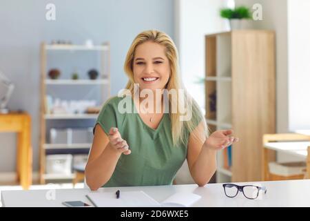 Smiling tutor, psychologist or company manager having video call with students or clients Stock Photo