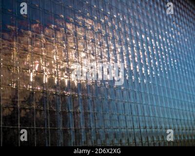 Close up of reinforced wired glass with an vague outdoor reflection - Selective focus Stock Photo