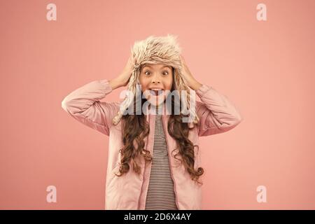 Playful kid girl wear fur hat 