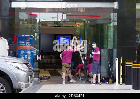 face mask wearing Builders working at weekend  at Metro Bank Branch, London. England Stock Photo
