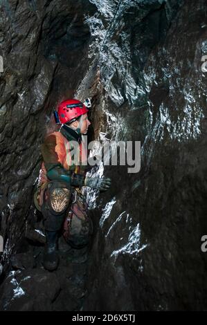 Ancient miners' gunpowder shotholes in the wall of a mineral vein in Odin Mine, Castleton, Derbyshire Stock Photo