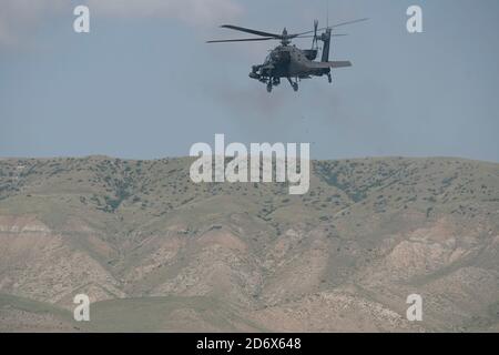 A U.S. AH-64 Apache helicopter fires away during a call to fire training with U.S. Soldiers from the 4th Squadron, 2d Cavalry Regiment and 12th Combat Aviation Brigade at the Vaziani Training Area, Georgia, Sept. 14, 2020.     The 4/2 Soldiers successfully completed their training exercise at the Vaziani Training Area in Georgia from September 7th to September 18th. Designed to enhance regional partnerships and increase U.S. force readiness and interoperability, the exercise allows participants to conduct sniper and demo ranges, situational training exercises, live-fire exercises and combined Stock Photo