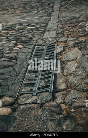 Road surface, old paving stone on the pavement. Stock Photo