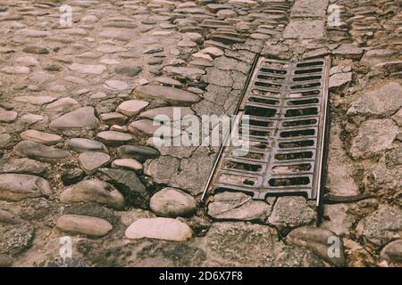 Road surface, old paving stone on the pavement. Stock Photo