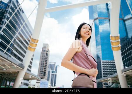 Asian Businesswoman with black hair smiling and looking away, business, happiness, confidence Stock Photo