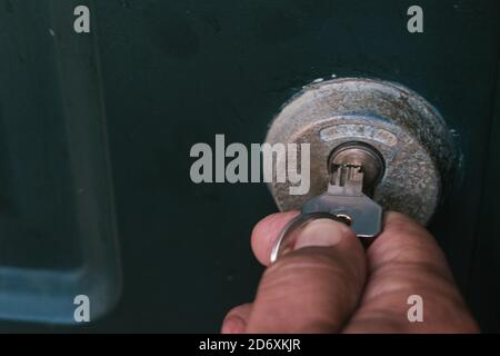 Selective focus shot of a male putting keys in a house lock Stock Photo