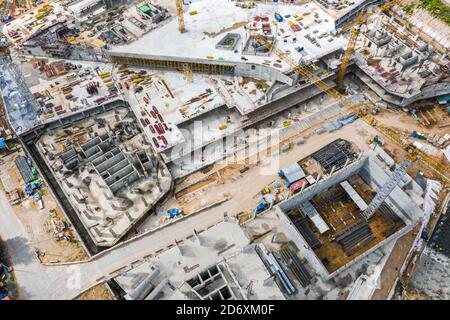 aerial top view of the foundation of buildings under construction. cranes working on under construction site Stock Photo