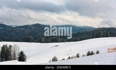 Panoramic winter view of Beskid Sadecki mountains from ski slope in Krynica Zdroj, Poland Stock Photo