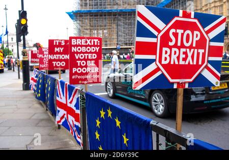 Anti-Brexit campaign posters being used by protesters outside the Houses of Parliament, London, in protest of the UK leaving the European Union.. Stock Photo