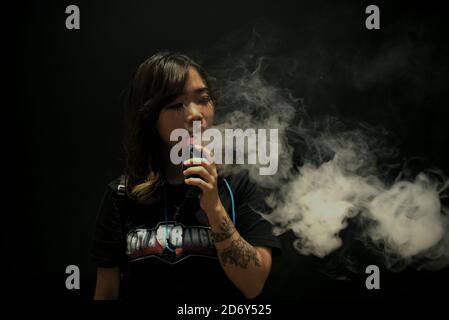 Portrait of woman vape cloud performer, Deborah Chen, during the annual Vape Fest in Jakarta, Indonesia. Stock Photo