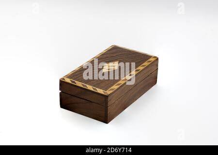 Closeup shot of a closed dark wooden long box isolated on a white background Stock Photo