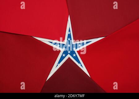 Fat quarters of fabrics red and white colors lying in the shape like a star on blue fabric with white stars pattern Stock Photo