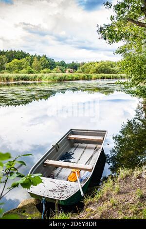 Fishermen boat on the shore of Konsky rybnik pond in Czech republic Stock Photo