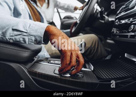 Male hand on gear shift lever in a luxury car Stock Photo