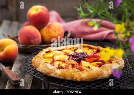 Rustic open pie (galette) with peach and cherry Stock Photo