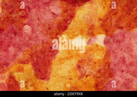 Bright red and orange background of crumpled paper or rough plaster for design or text. Surface texture. Close-up. Abstract. Stock Photo