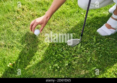 Young woman golfer preparing for a game Stock Photo