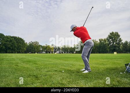Sportsman practicing swings on the driving range Stock Photo