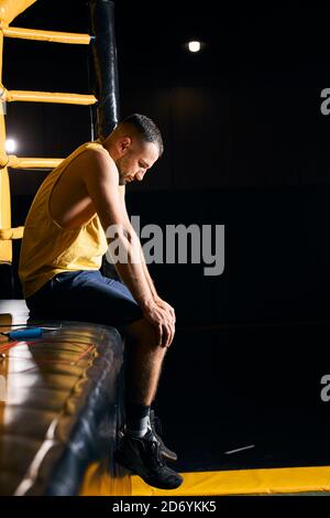 Upset fighter resting with the hands on his knees Stock Photo