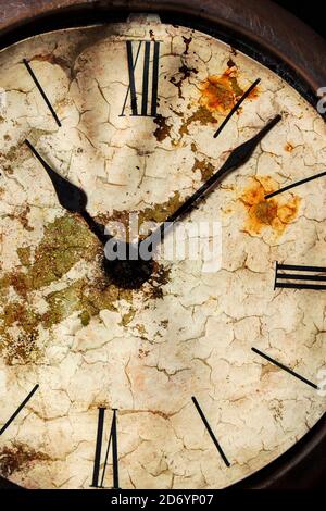 Distressed old clock face with Roman numerals. Stock Photo