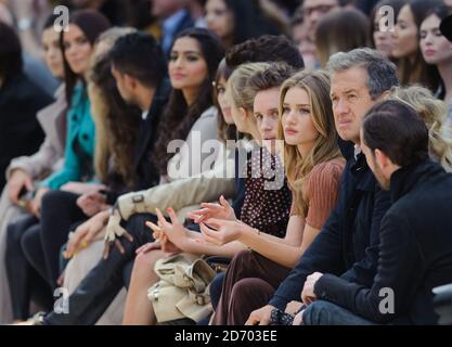 Amir Khan, Eddie Redmayne, Rosie Huntington-Whiteley and Mario Testino watching the Burberry Prorsum show at Kensington Gore, London, during London Fashion Week. Stock Photo