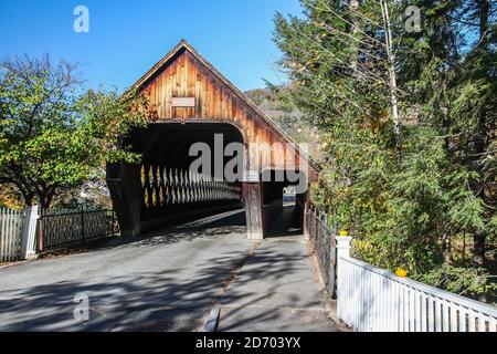 WOODSTOCK, VT, USA - OCTOBER 9, 2020: Woodstock Middle bridge build in 1969 near Central Street with morning autumn lights and blue sky Stock Photo