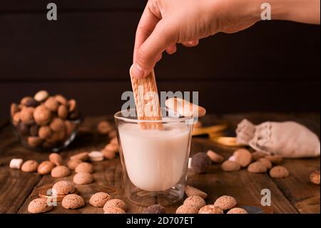Dutch holiday Sinterklaas. Pepernoten and milk on wooden background. Copy space.  Stock Photo