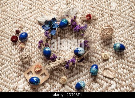 Stylish composition with an Easter wreath and eggs trend blue. The concept of Easter decorations and celebration. Stock Photo