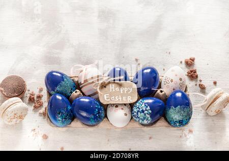 Stylish beautiful composition with blue Easter eggs on a white wooden background. The concept of Easter decorations and celebration. Stock Photo