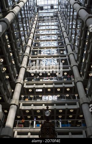 Lloyds of London modern building interior view of people on escalator ...