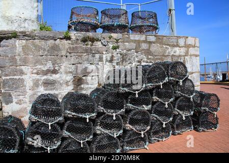 Lobster traps and crab pots at a dock in Brixham Devon England UK used by the fishing industry Stock Photo