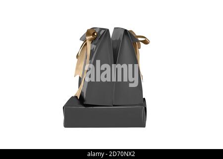Black paper bag with a gold ribbon isolated over white background Stock Photo