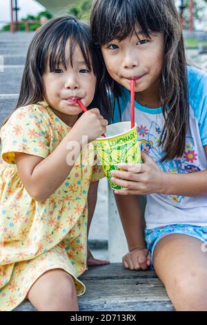 Miami Florida,Bayfront Park Japanese Festival annual Asian girl girls kid kids children sisters siblings,drinking straw straws, Stock Photo