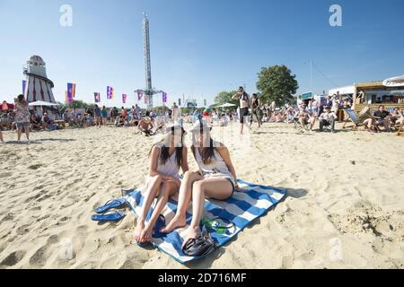 Festival enjoy the sunshine at the Isle of Wight Festival, at Newport on the Isle of Wight. Stock Photo