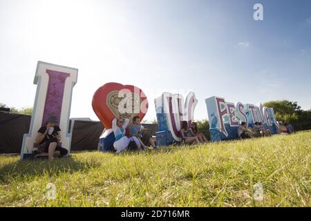 Festival enjoy the sunshine at the Isle of Wight Festival, at Newport on the Isle of Wight. Stock Photo