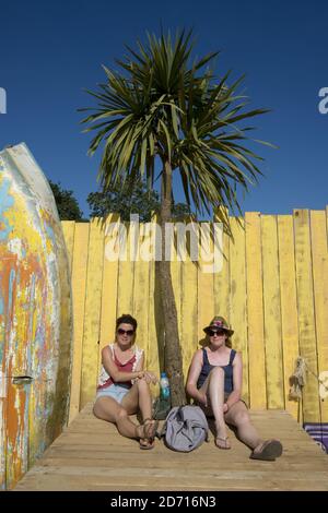 Festival enjoy the sunshine at the Isle of Wight Festival, at Newport on the Isle of Wight. Stock Photo