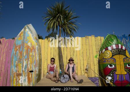 Festival enjoy the sunshine at the Isle of Wight Festival, at Newport on the Isle of Wight. Stock Photo