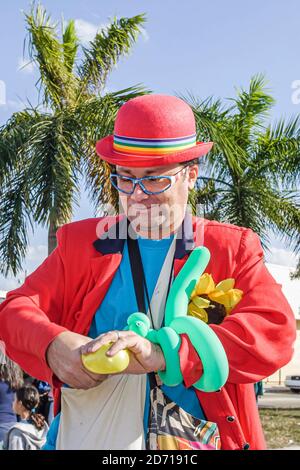 Miami Florida,Little Havana,Hispanic Calle Ocho,Tres Reyes Magos Three 3 Kings parade,street performer clown balloon artist balloons making twisting a Stock Photo