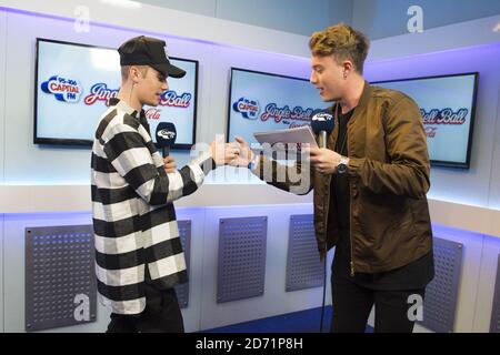 Justin Bieber pictured with presenter Roman Kemp during the Capital FM Jingle Bell Ball 2015 at the O2 Arena, London. Stock Photo