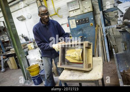 Rupert Francis prepares casts during the making of Bafta awards, at a foundry in West Drayton, Middlesex, ahead of the award ceremony in February. Designed by US sculptor Mitzi Cunliffe, New Pro Foundries has been making the bronze casts since the ceremony was created in 1976. Picture date: Tuesday January 31, 2016. Photo credit should read: Matt Crossick/ EMPICS Entertainment. Stock Photo