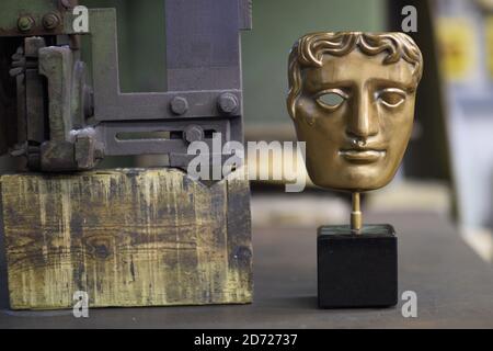 A finished mask during the making of Bafta awards, at a foundry in West Drayton, Middlesex, ahead of the award ceremony in February. Designed by US sculptor Mitzi Cunliffe, New Pro Foundries has been making the bronze casts since the ceremony was created in 1976. Picture date: Tuesday January 31, 2016. Photo credit should read: Matt Crossick/ EMPICS Entertainment. Stock Photo