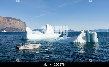 Harbor with kids fishing and typical fishing boats. Small town of Uummannaq  in northwest Greenland, Denmark (Editorial Use Only Stock Photo - Alamy