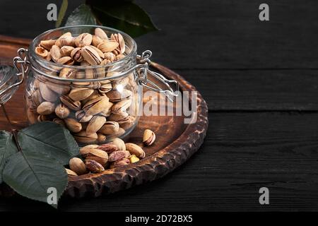 Pistachios nuts on dark background, top view, healthy snack Stock Photo