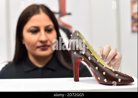 Azra Sadiq of Azra chocolates puts the finishing touches to a chocolate shoe, at The Chocolate Show, at Olympia in Kensington, London. Picture date: Friday October 13th, 2017. Photo credit should read: Matt Crossick/ EMPICS Entertainment. Stock Photo