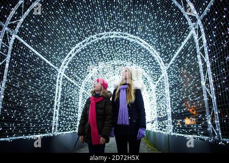 Visitors at Kew gardens in West London, at the launch of Christmas at Kew - an after-dark walk featuring light and sound installations. Picture date: Tuesday November 21st, 2017. Photo credit should read: Matt Crossick/ EMPICS Entertainment. Stock Photo