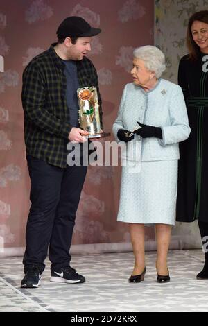 Queen Elizabeth II presents the Queen Elizabeth II Award for British Design to designer Richard Quinn, after his London Fashion Week show, held at the BFC showspace, London. Picture date: Tuesday February 20th 2018. Photo credit should read: Matt Crossick/ EMPICS Entertainment. Stock Photo