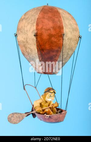 Toy hot air balloon isolated on blue background Stock Photo