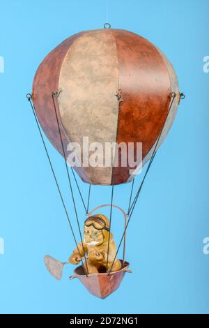 Toy hot air balloon isolated on blue background Stock Photo