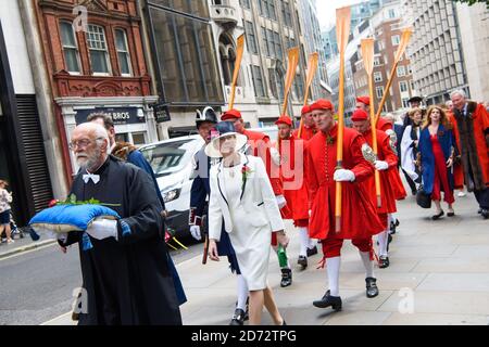 Members of the Company of Watermen and Lightermen of the River Thames, and members of the church of All Hallows by the Tower, carry a rose through the City of London during the Knolly's Rose Ceremony. The ceremony, which dates back to 1381, sees a peppercorn rent of a single rose being paid annually to the Lord Mayor, after  soldier Sir Robert Knollys of Seething Lane built an illegal footbridge over the road to his rose garden. Picture date: Wednesday 20th June, 2018. Photo credit should read: Matt Crossick/ EMPICS Entertainment. Stock Photo